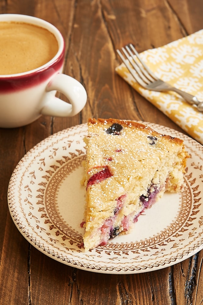 slice of Berry Muffin Cake on a floral-rimmed beige plate