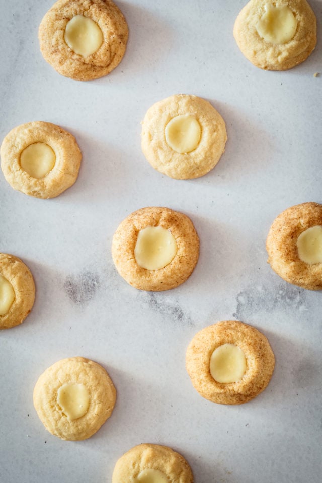 overhead view of Cheesecake Thumbprint Cookies on a marble surface