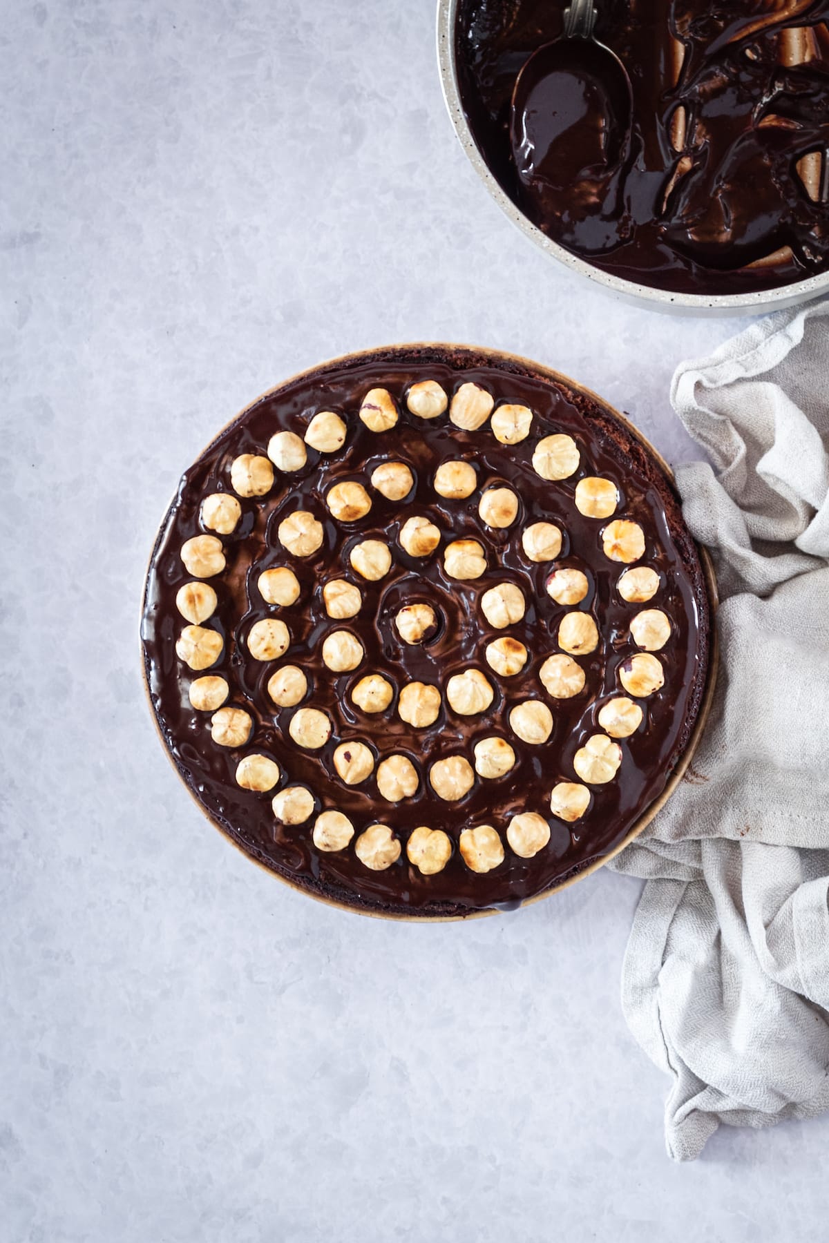 overhead of a cake with hazelnuts on top