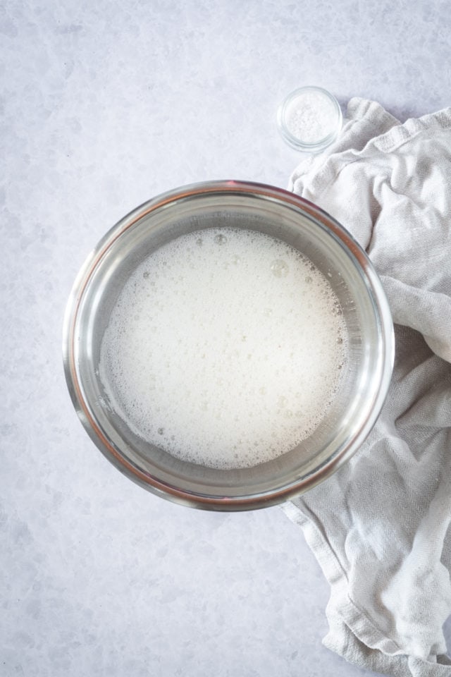 egg whites in a mixing bowl beaten to a foam