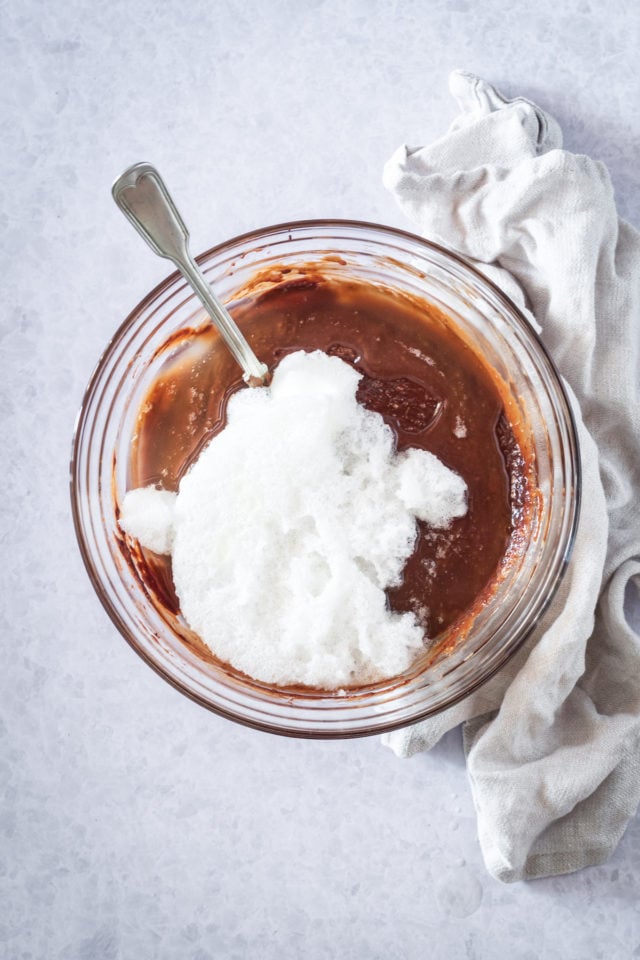 bowl of chocoalte cake batter with egg white foam on top