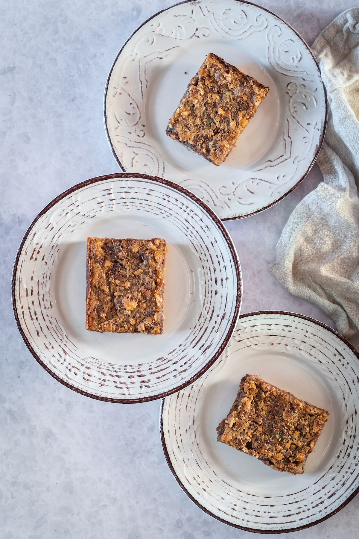 three plates with three chocolate pecan bars 