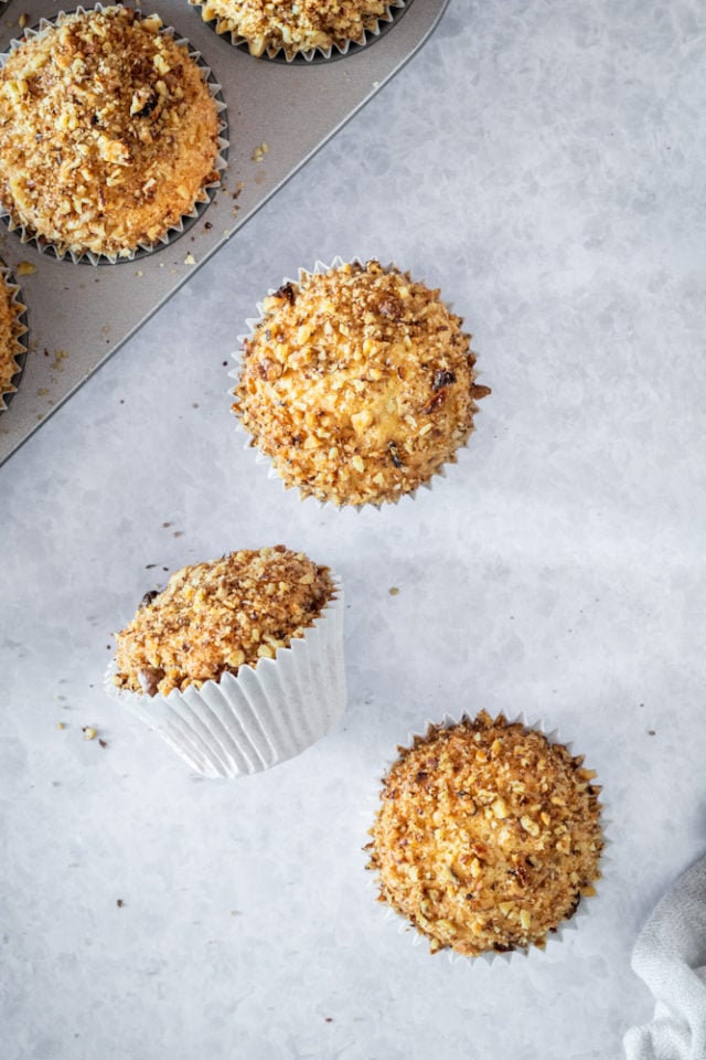 overhead view of coffee cake muffins on a light gray surface