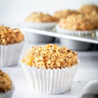 Sour Cream Coffee Cake Muffins on a light gray surface