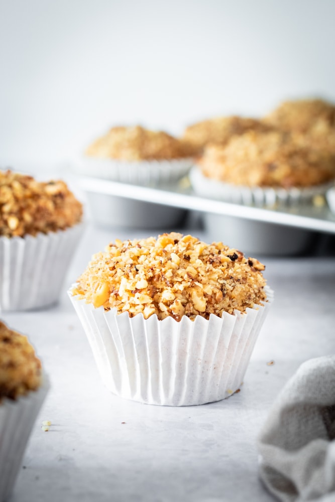 Sour Cream Coffee Cake Muffins on a light gray surface