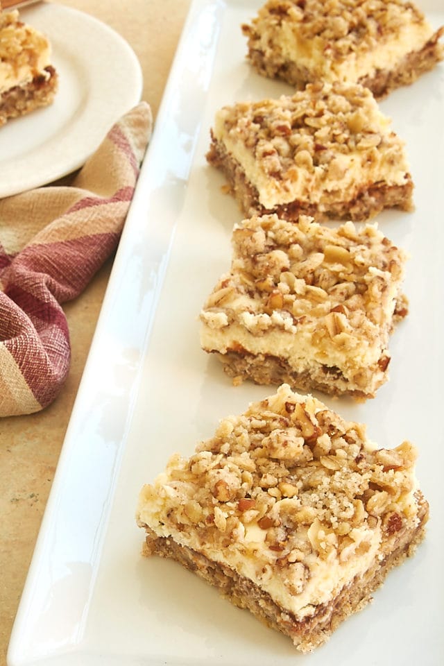 apple cheesecake bars on a long white platter