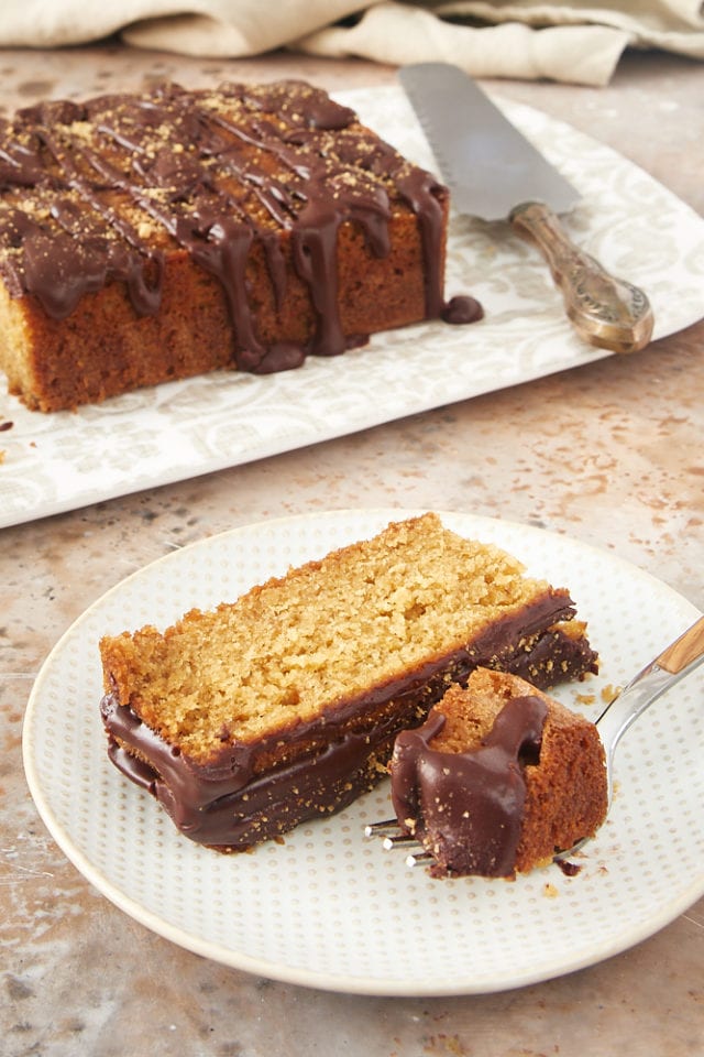 slice of graham cracker cake on a white and beige plate