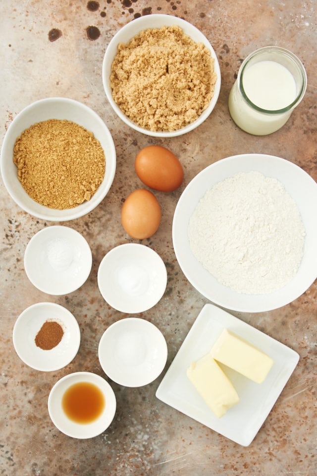 ingredients for graham cracker cake, including graham cracker crumbs, brown sugar, butter, and eggs