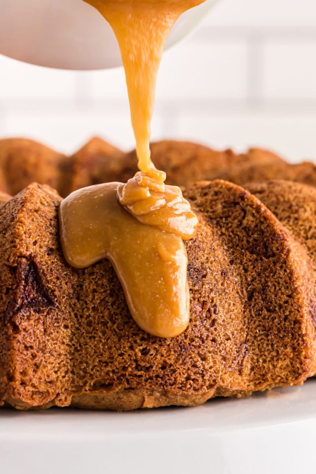 caramel glaze being poured onto Apple Spice Cake