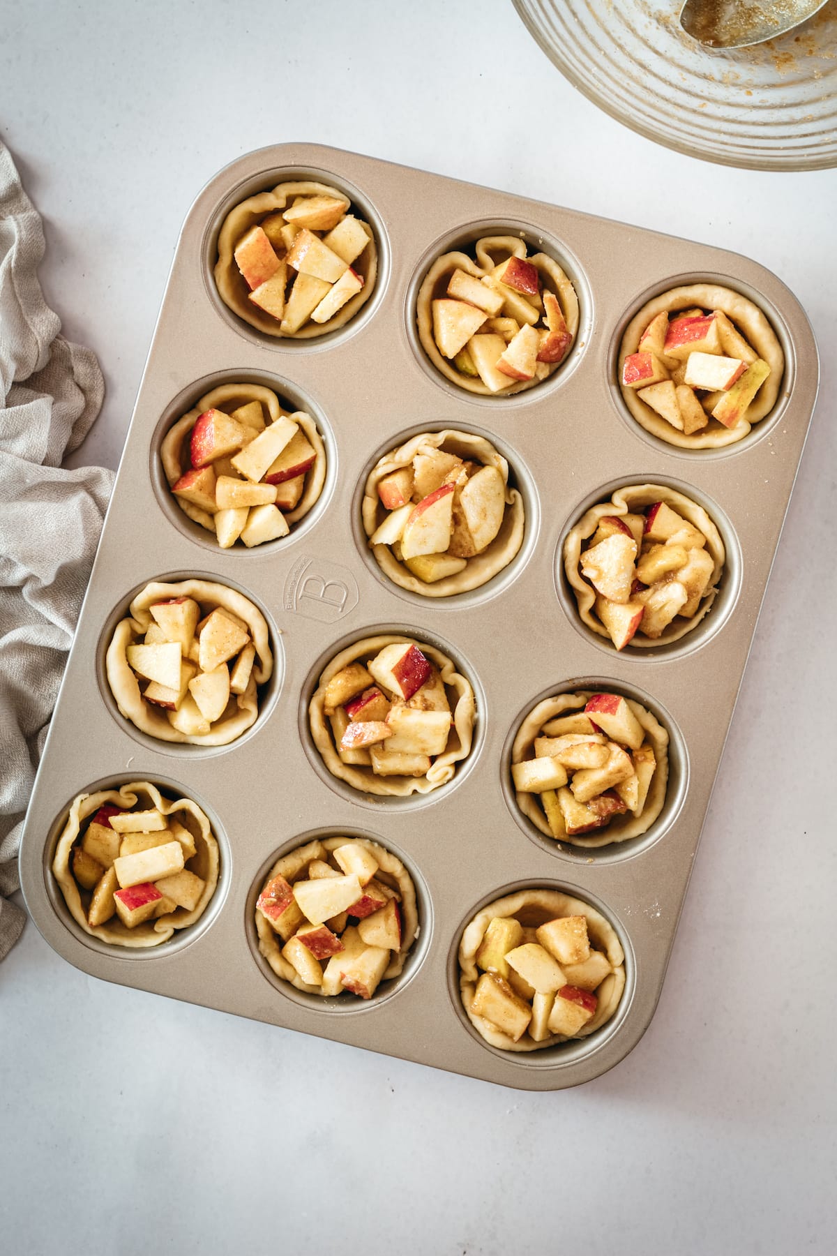 Overhead shot of Mini Caramel Apple Pies in muffin tin