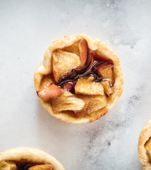 Overhead closeup of Mini Caramel Apple Pies on marble slab