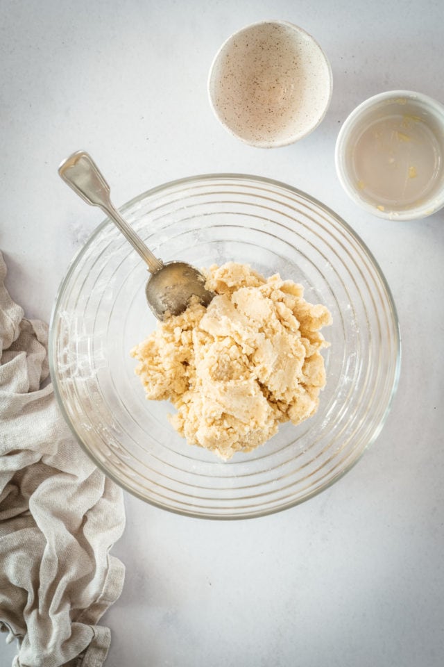 Overhead shot of pie dough in glass bowl