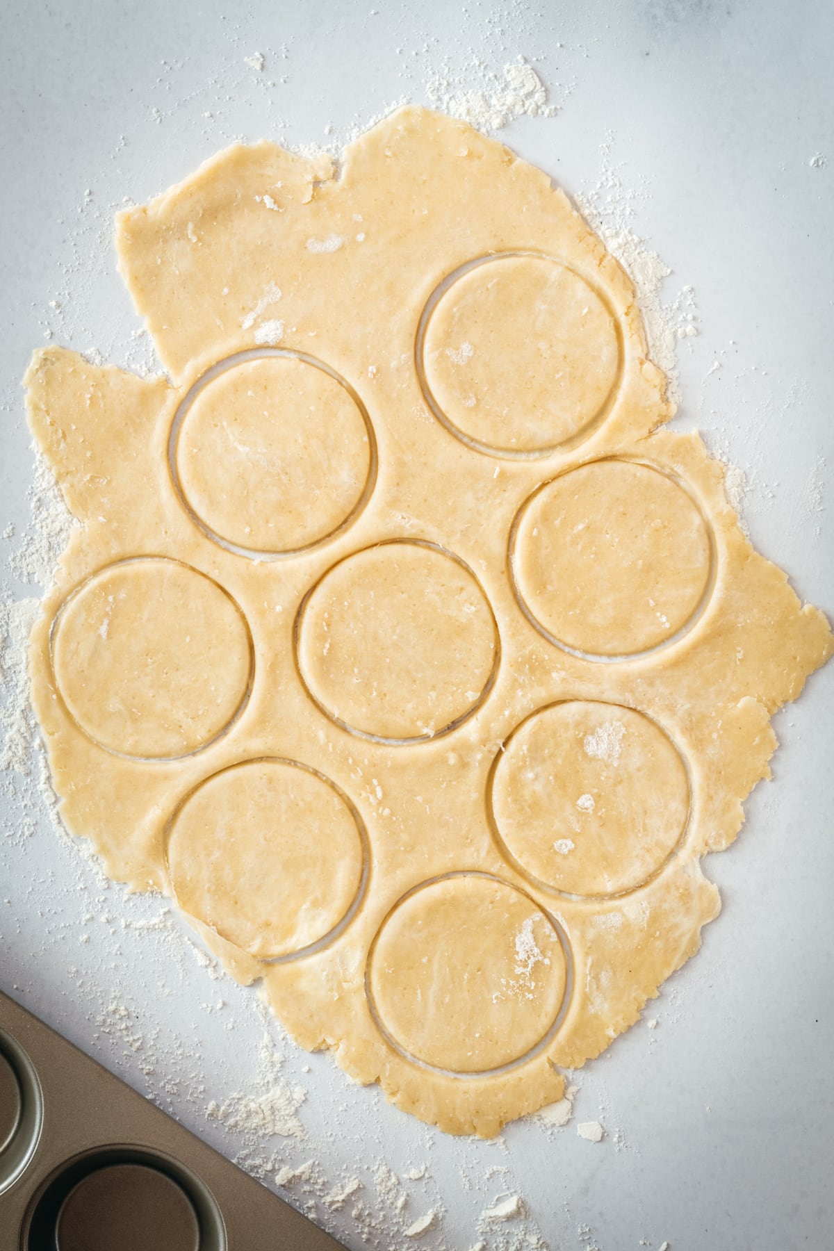 Overhead shot of circles being cut out of pie dough