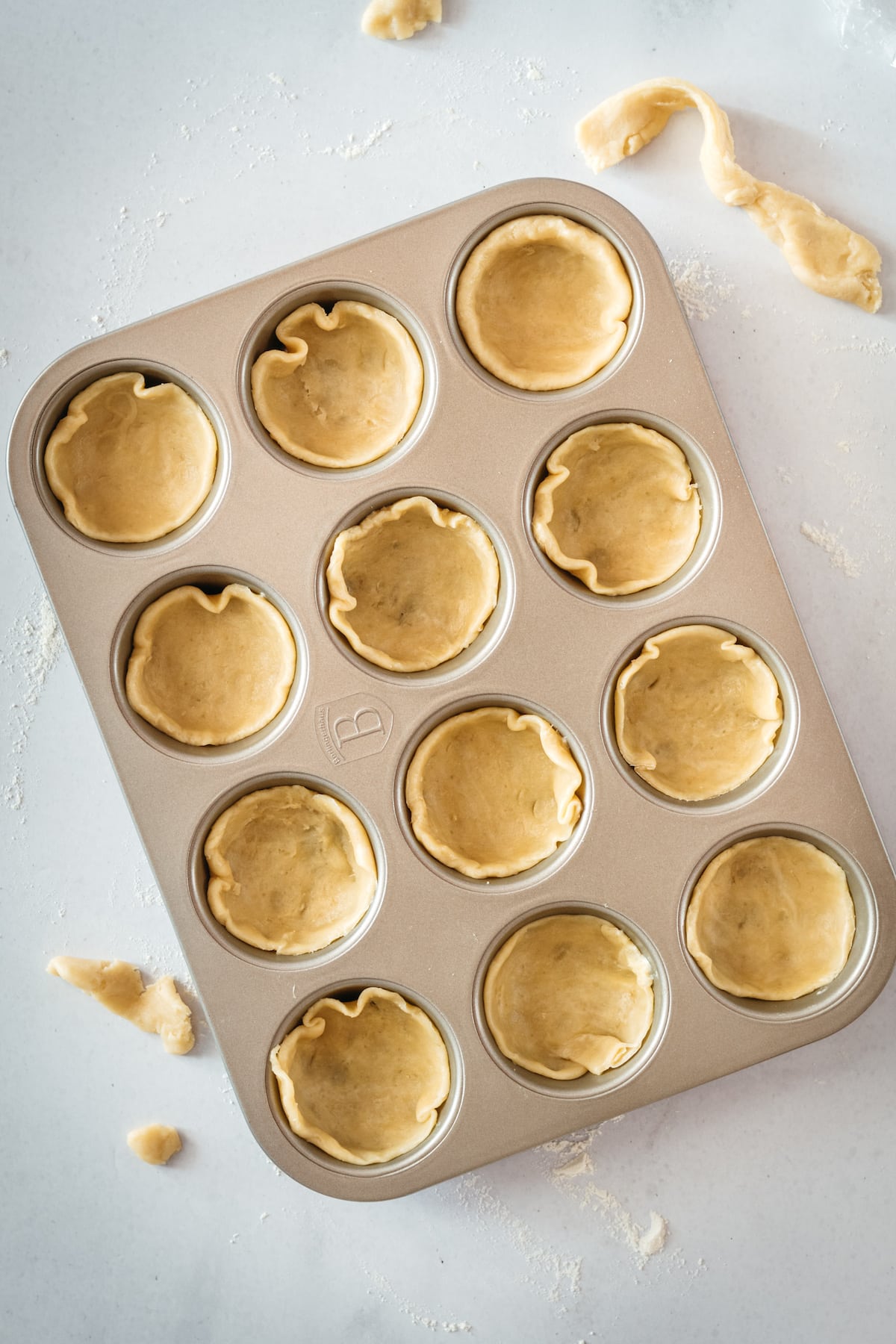 Overhead shot of pie crusts in muffin tin