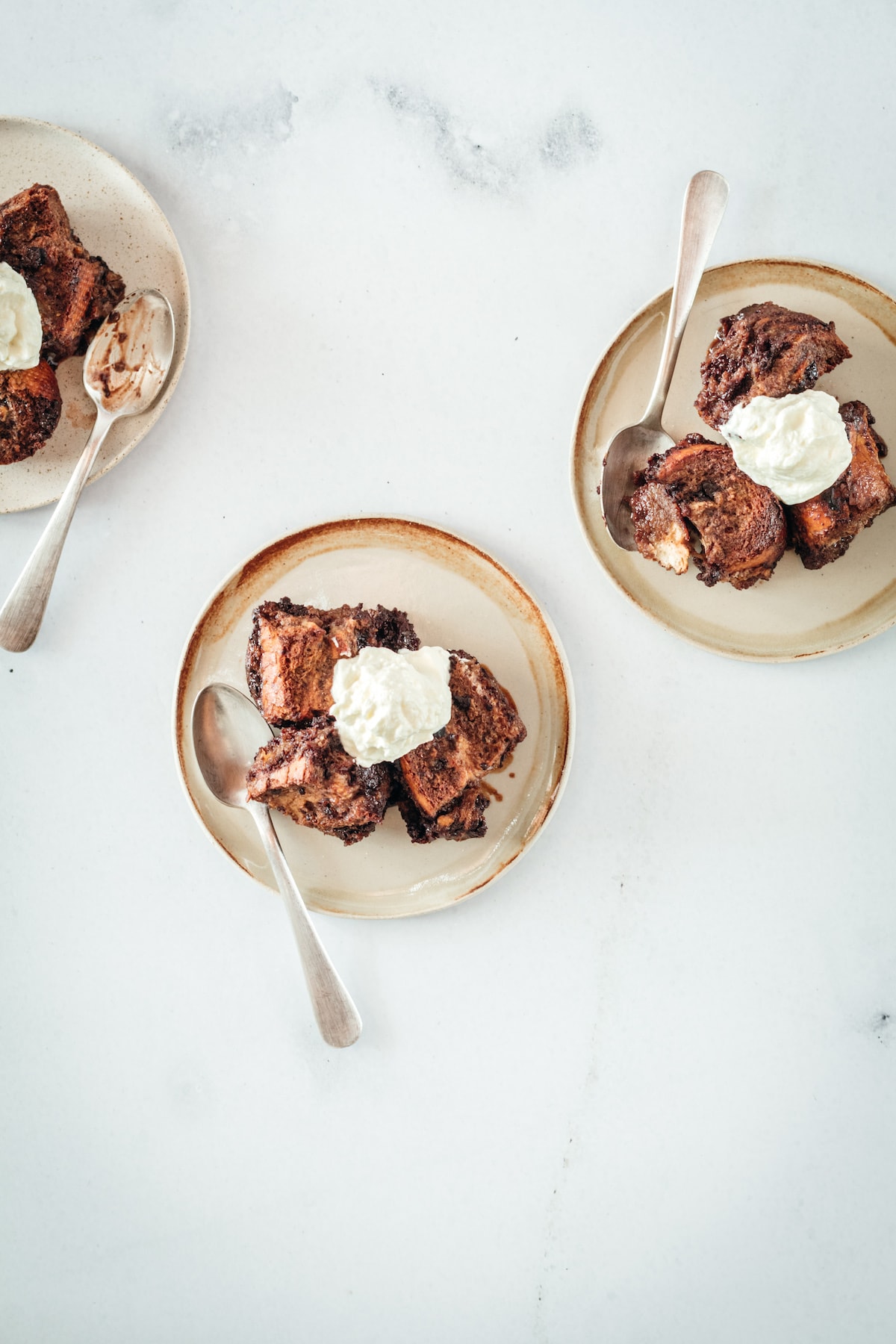 Overhead shot of 3 plates with Chocolate Bread Pudding