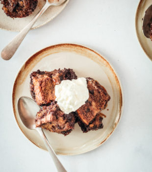 Overhead shot of Chocolate Bread Pudding on plates with whipped cream