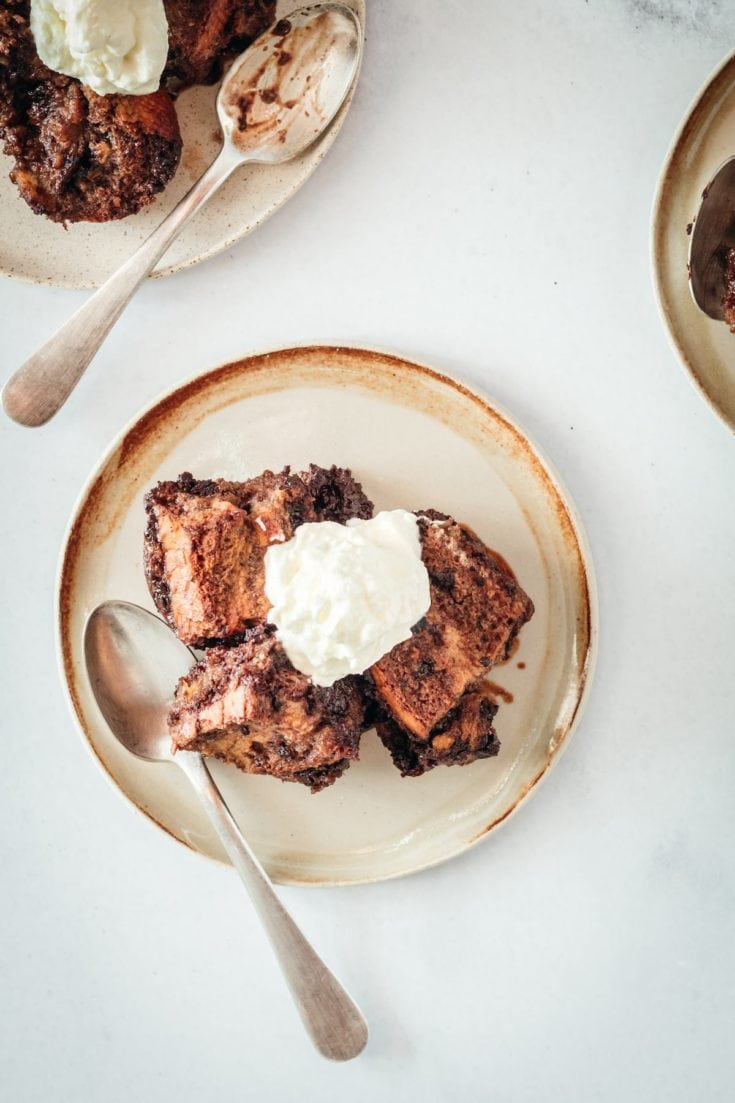 Overhead shot of Chocolate Bread Pudding on plates with whipped cream