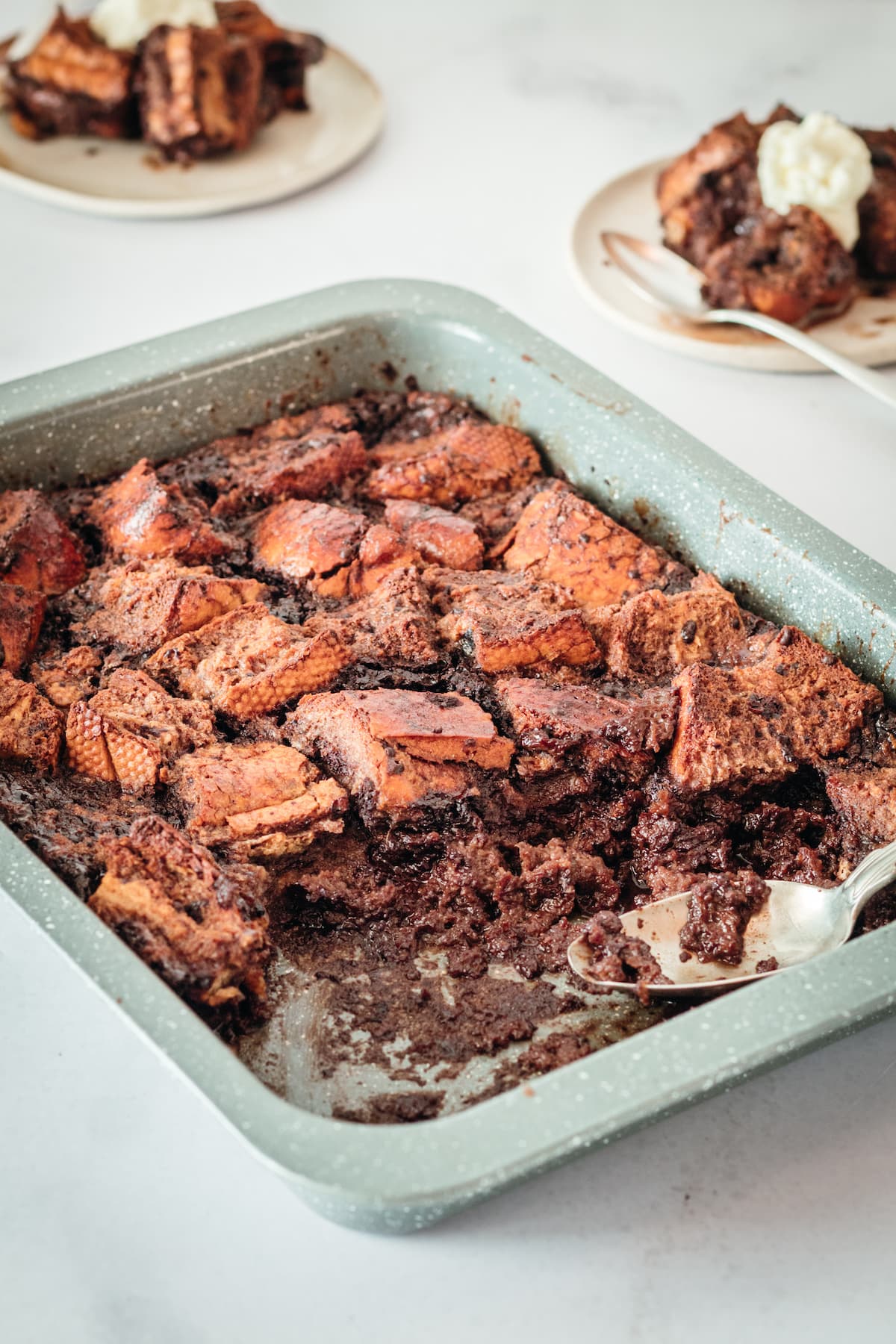 Chocolate Bread Pudding in baking dish with a few servings removed