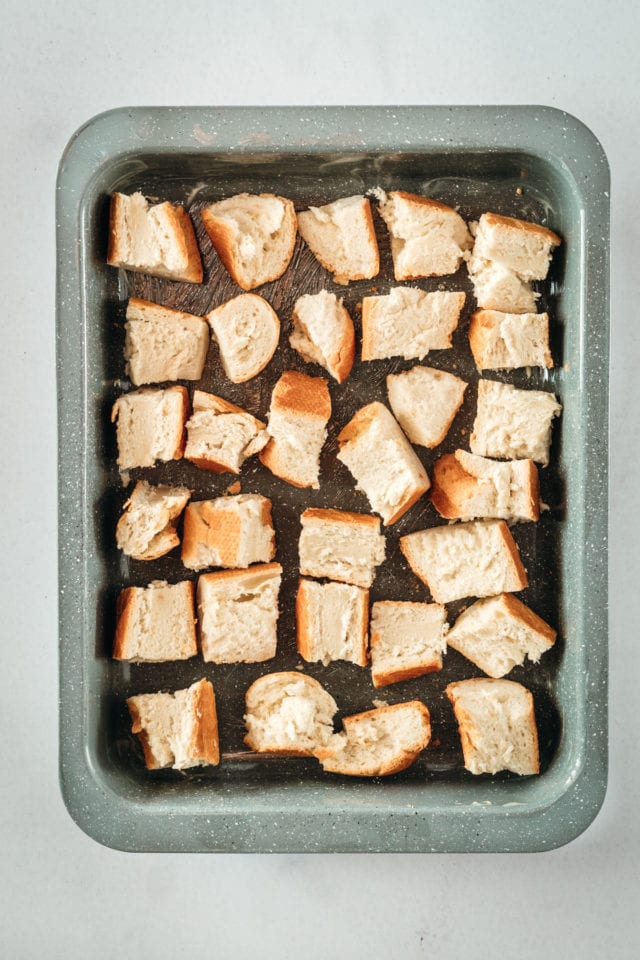 Overhead shot of cubed bread in baking dish