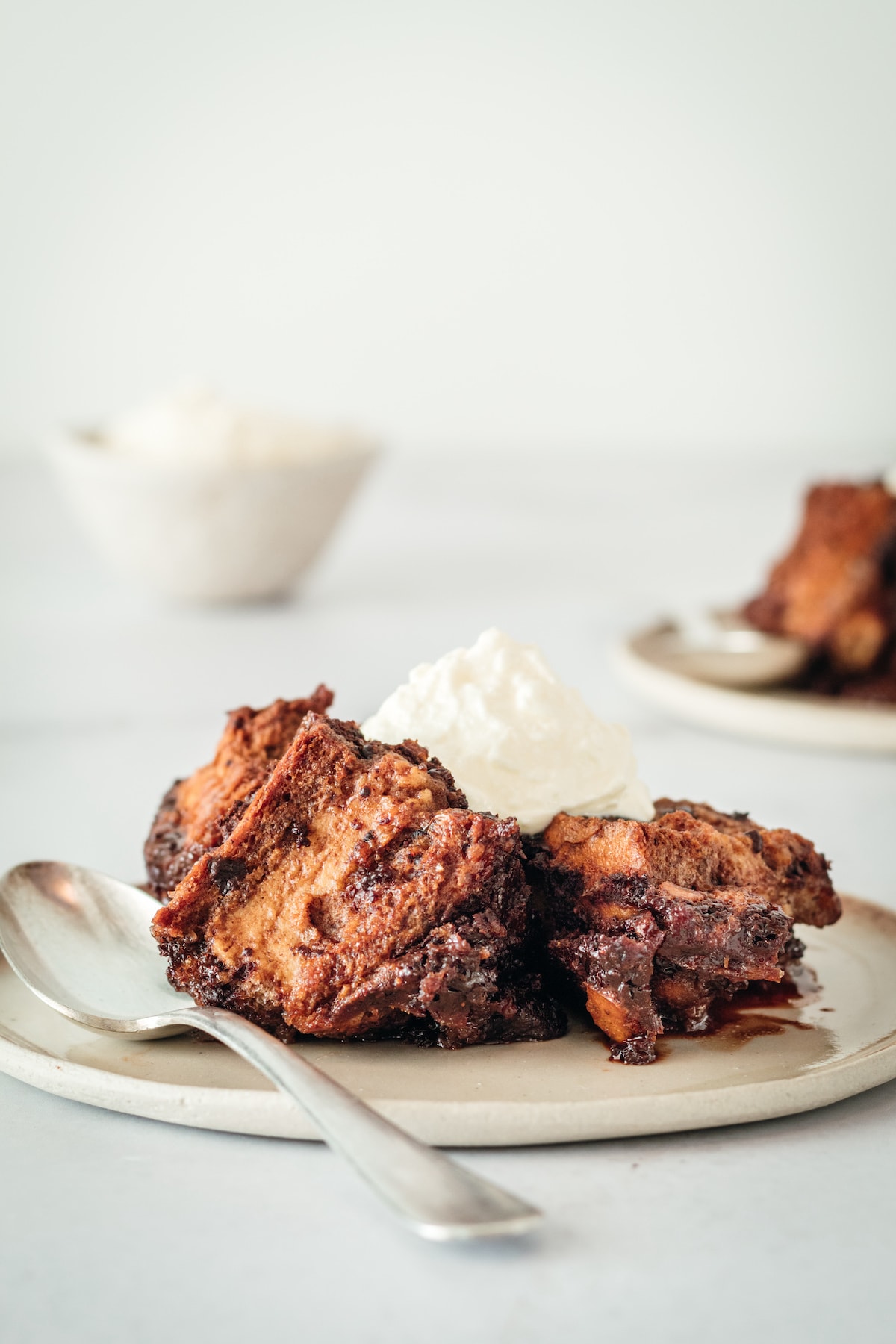 Chocolate Bread Pudding on plate with a dollop of whipped cream
