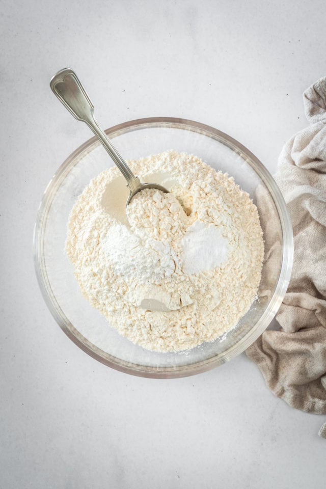 Overhead shot of dry cake ingredients in glass bowl