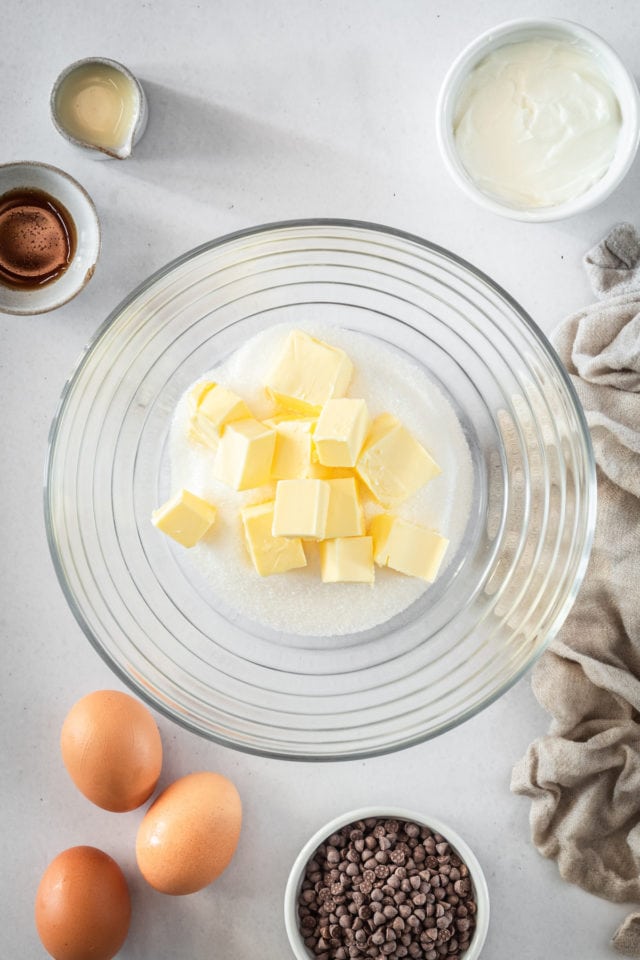 Overhead shot of butter and sugar in glass bowl