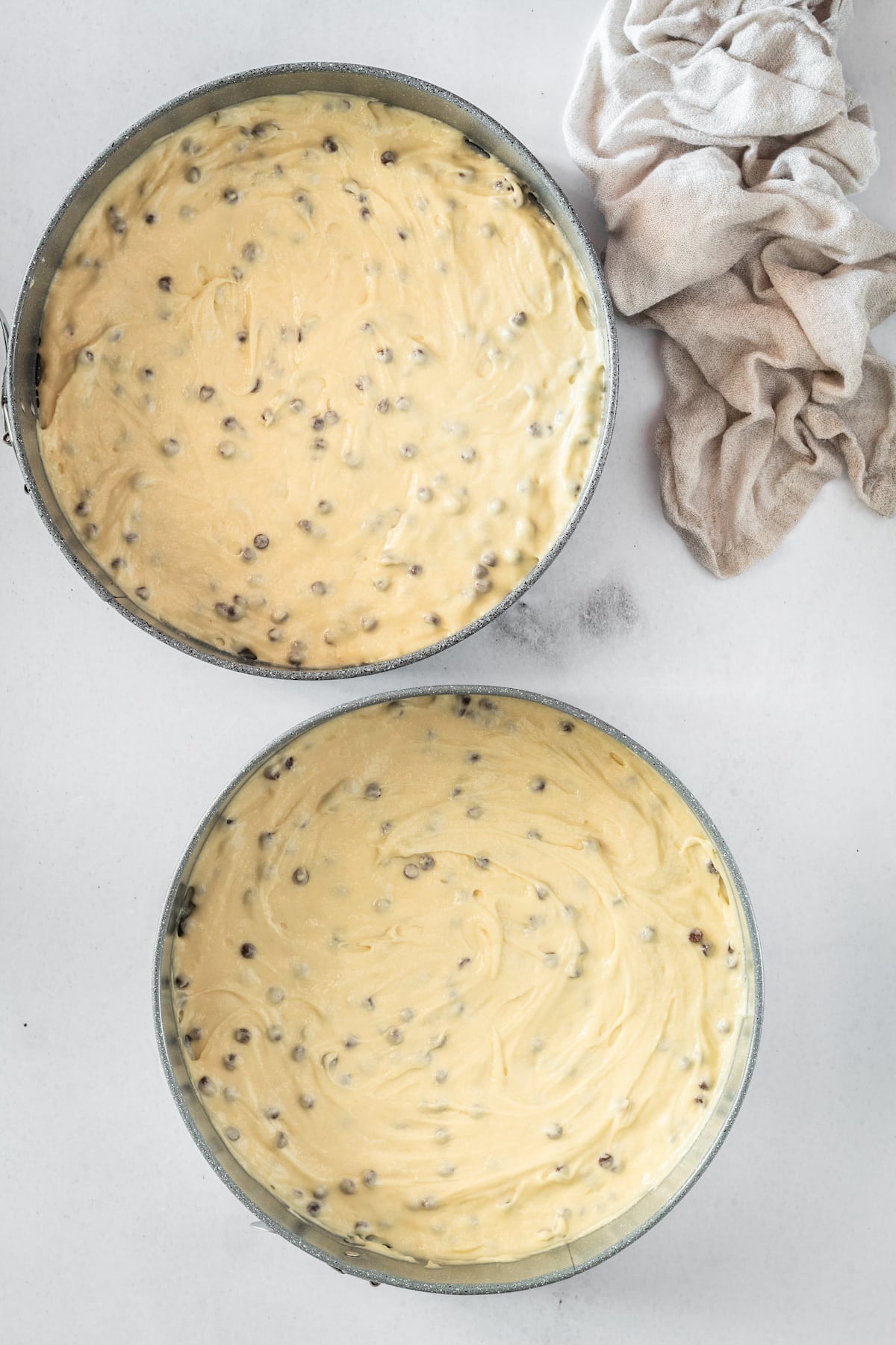 Overhead shot of Chocolate Chip Cake batter in two round pans
