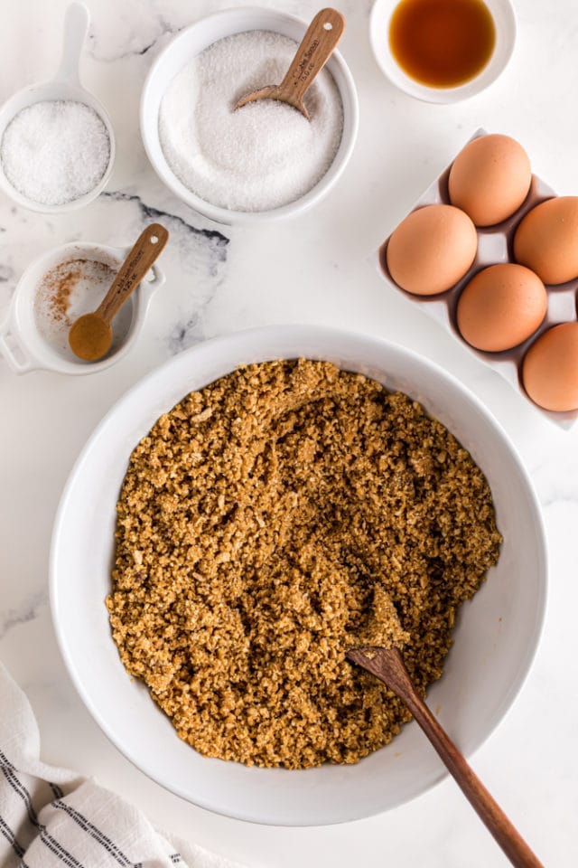 overhead view of graham cracker crust mixture in a mixing bowl