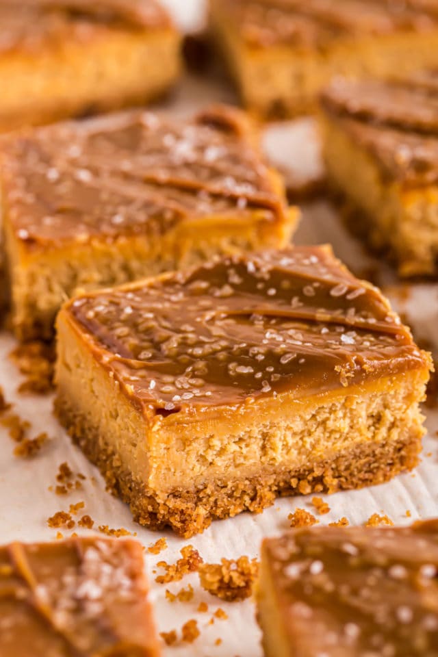 Dulce de Leche Cheesecake Bars on parchment paper