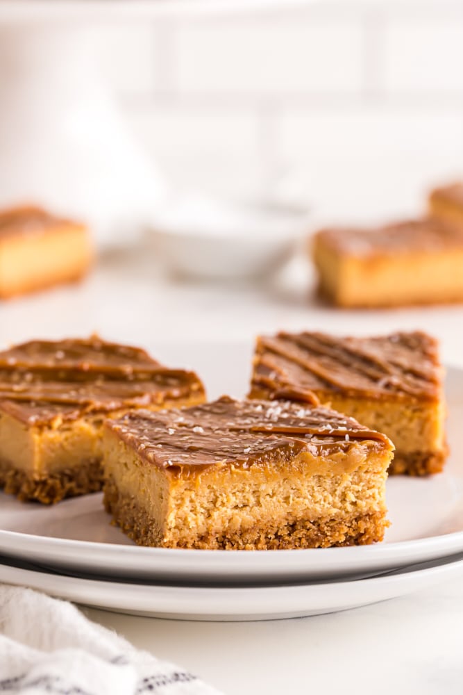 sliced Dulce de Leche Cheesecake Bars on a white plate