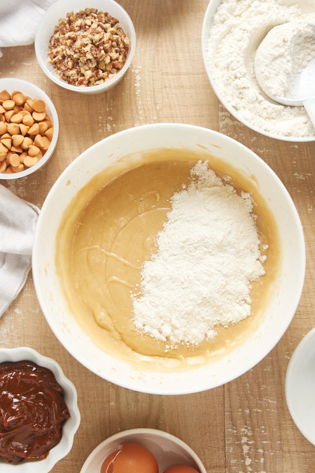 overhead view of dry ingredients added to wet ingredients for brown sugar cake