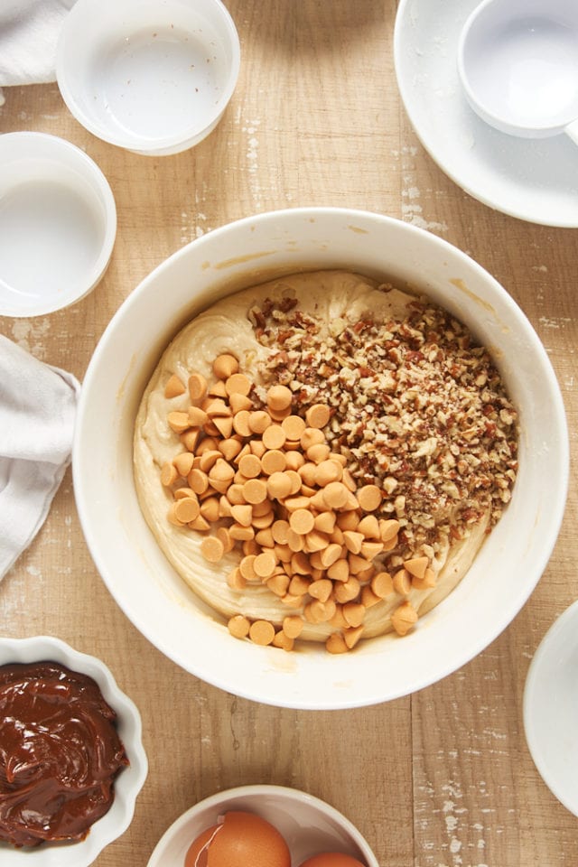 overhead view of nuts and butterscotch chips added to brown sugar cake batter