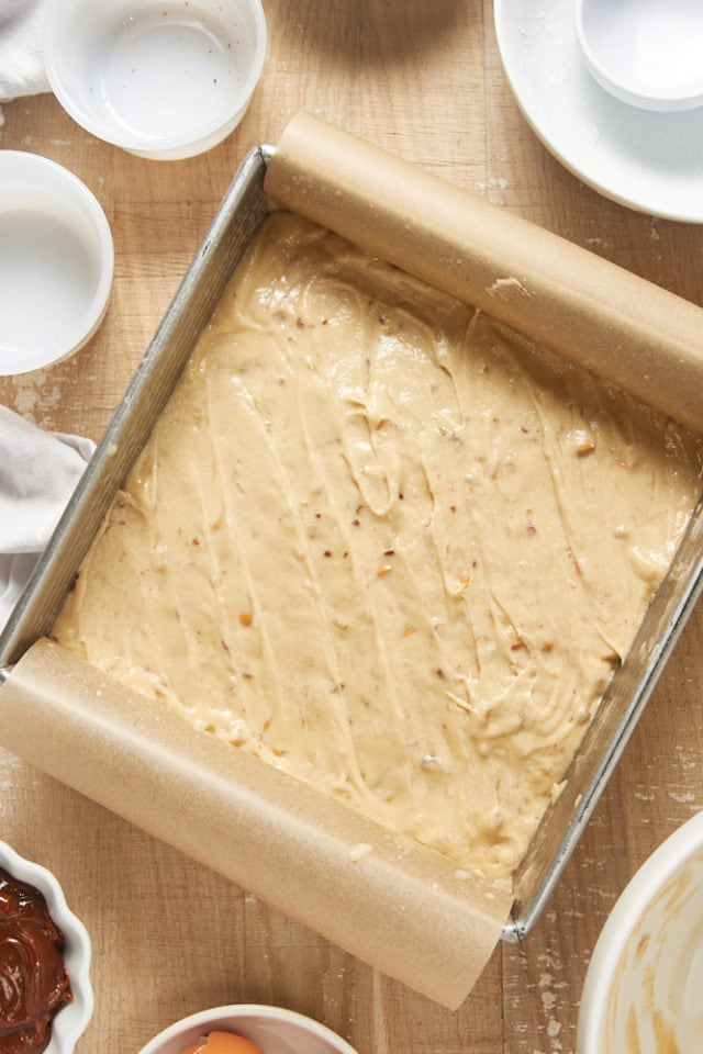 overhead view of Brown Sugar Snack Cake batter in a parchment-lined baking pan