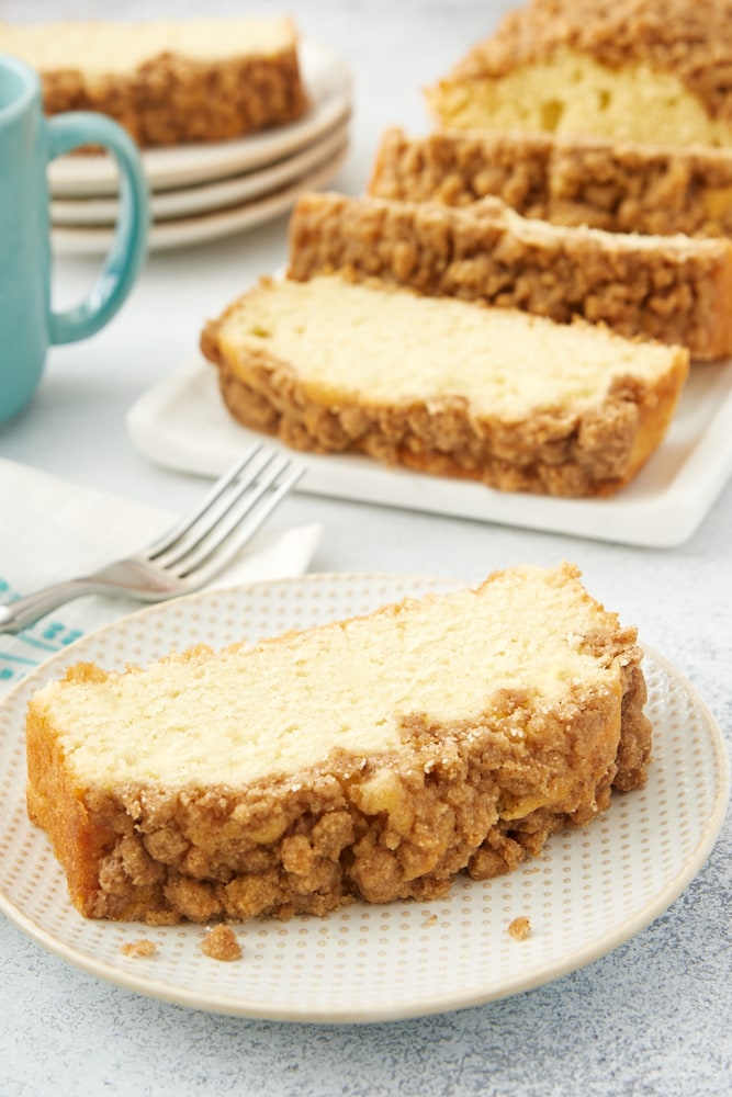 slice of Sour Cream Coffee Cake on a white and beige plate