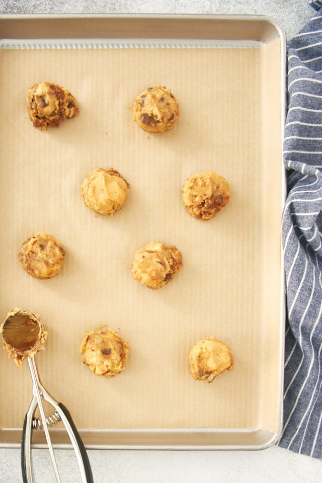 overhead view of Nutella Peanut Butter Cookie dough on a parchment-lined baking sheet