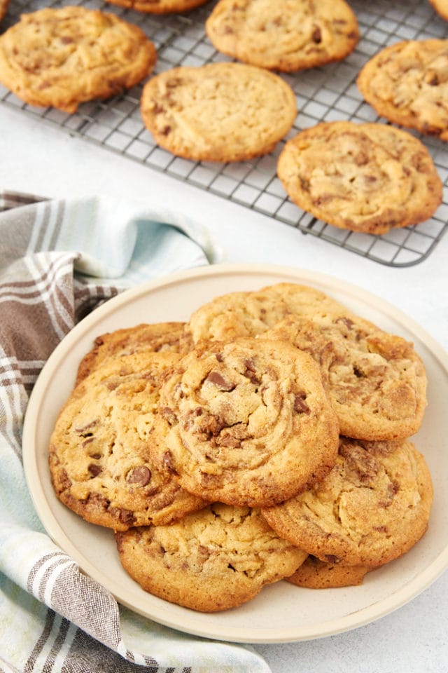 Nutella Peanut Butter Cookies on a beige plate and a wire rack