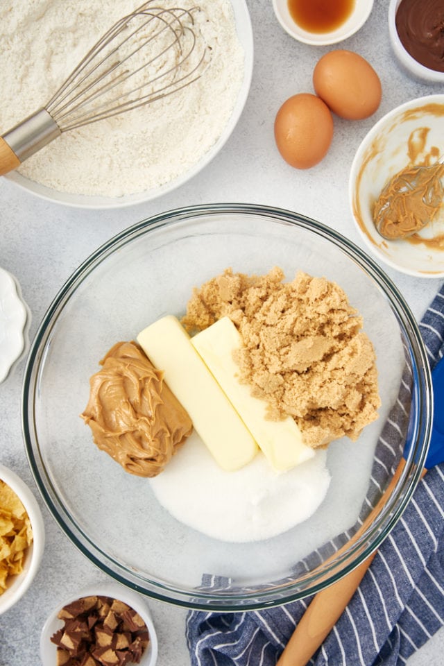 overhead view of butter, brown sugar, sugar, and peanut butter in a mixing bowl