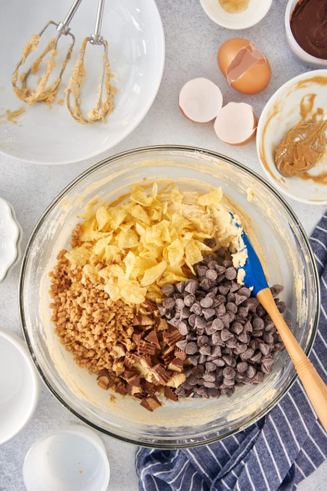 chocolate chips, potato chips, toffee bits, and peanut butter cups added to peanut butter cookie dough