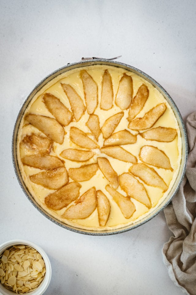 Overhead shot of pear tart after adding pear slices