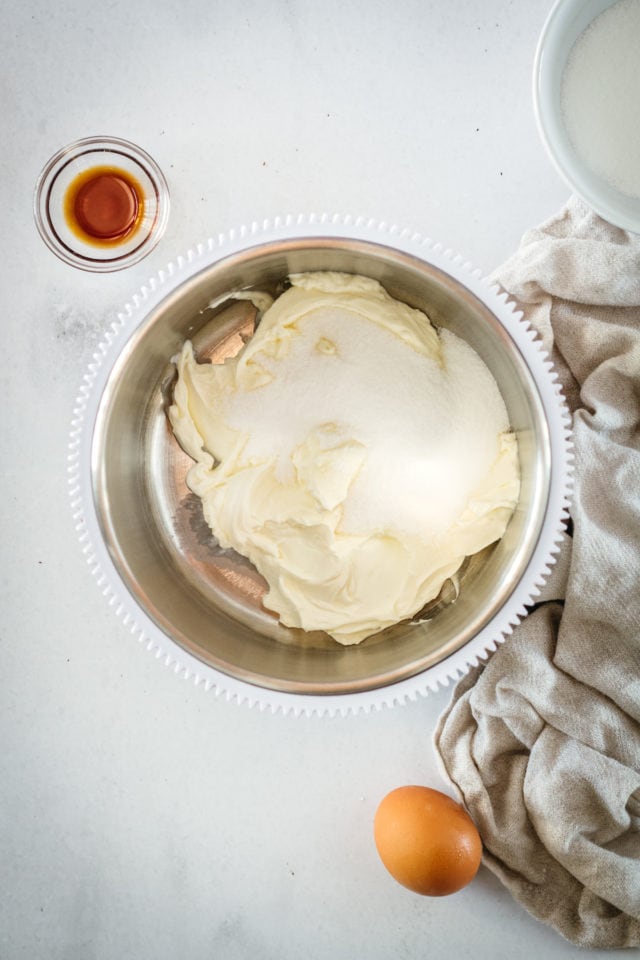 Overhead view of cream cheese and sugar in mixing bowl