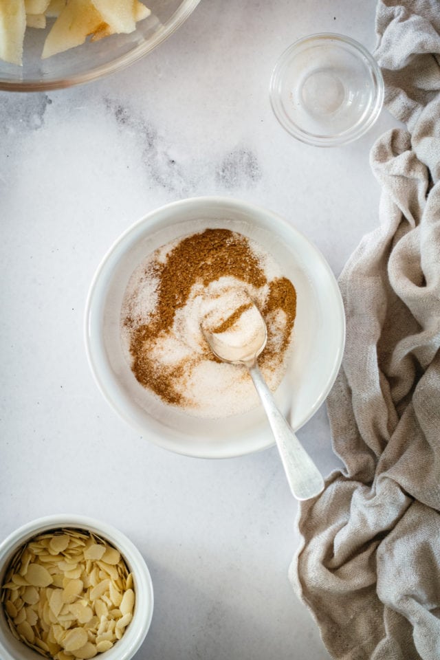 Overhead shot of cinnamon and sugar in bowl with spoon