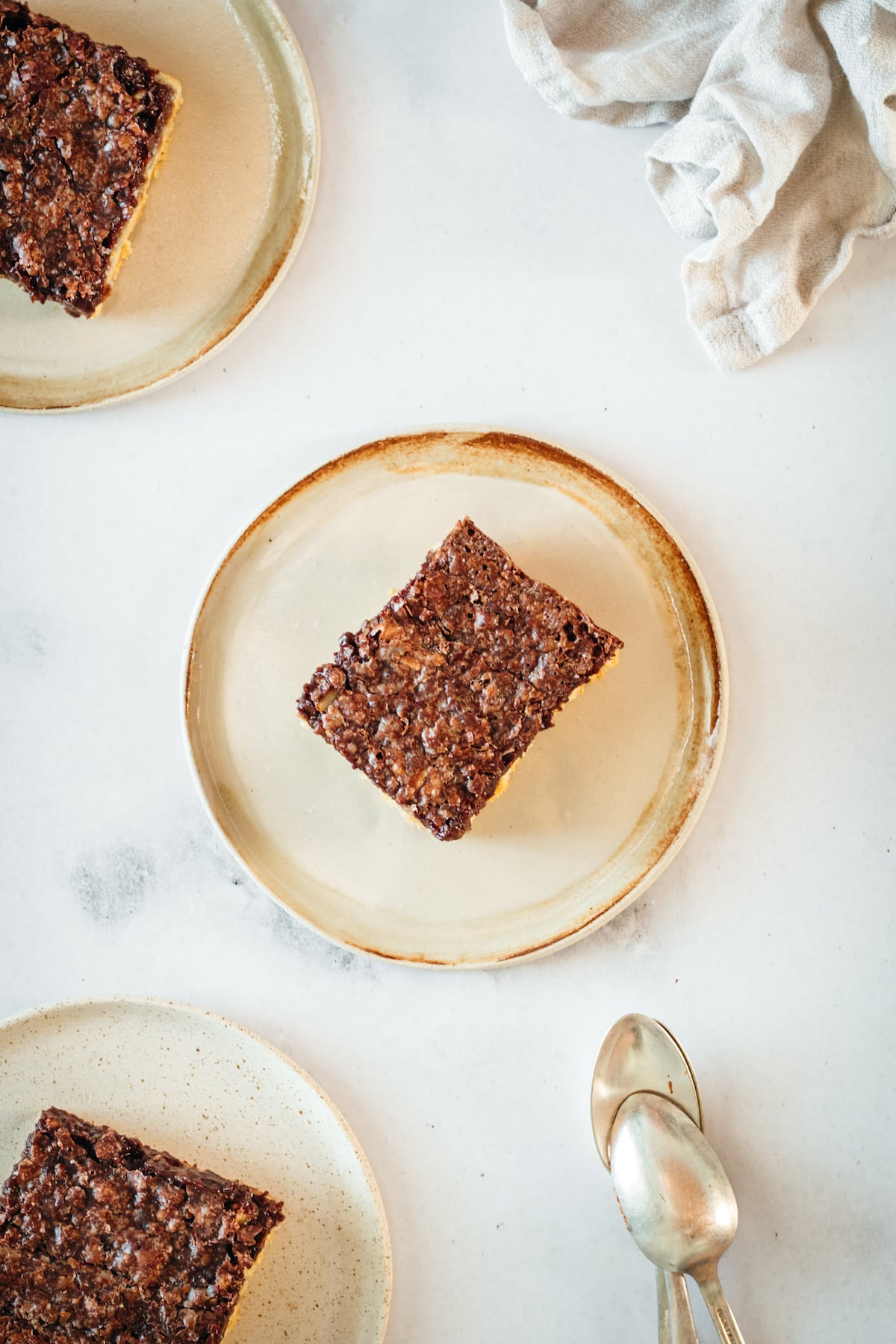 Overhead view of pecan pie bars on 3 plates