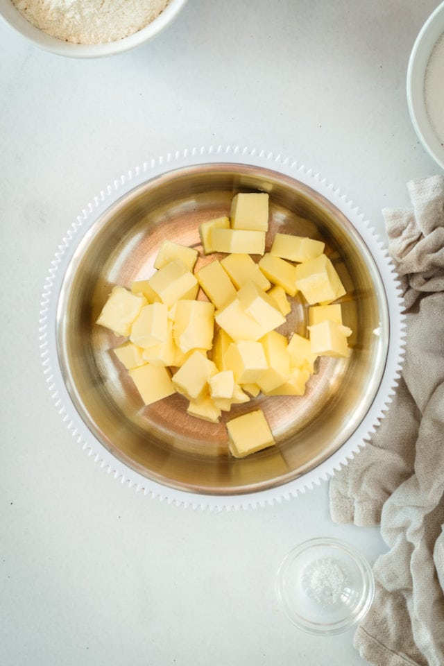 Overhead view of butter pieces in mixing bowl