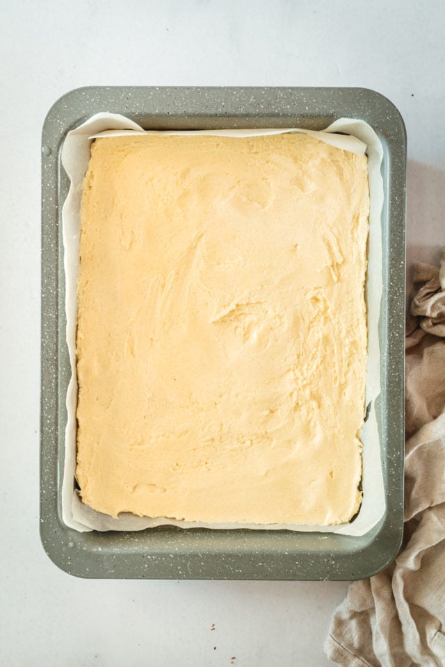 Overhead view of unbaked shortbread crust in baking pan