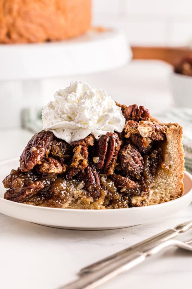 slice of Deep-Dish Pecan Pie topped with whipped cream