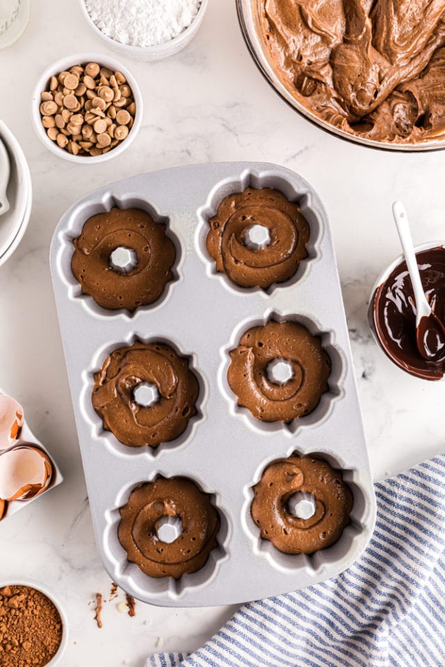 mini bundt pan partially filled with chocolate cake batter