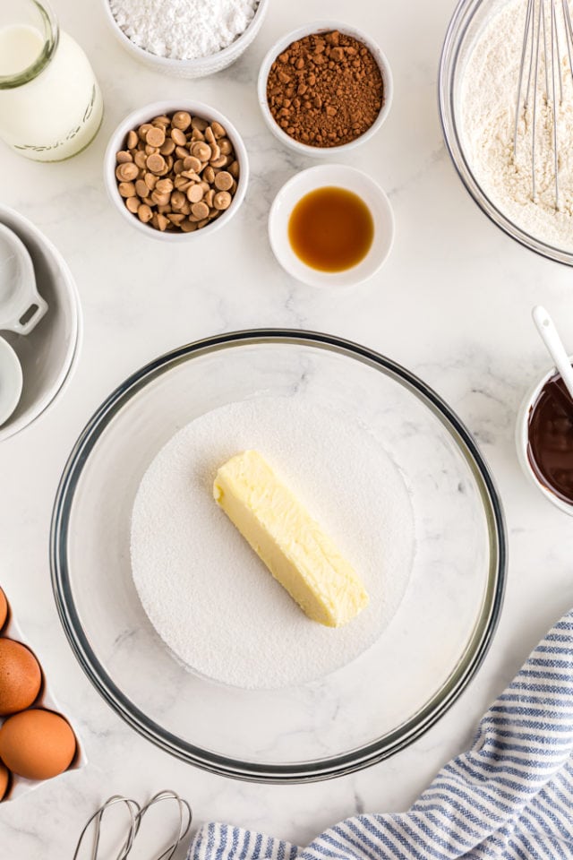 overhead shot of sugar and butter in a glass mixing bowl