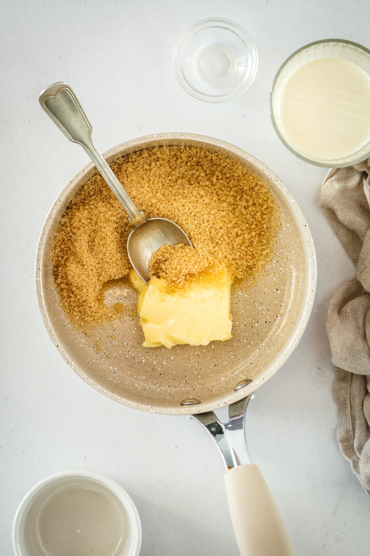 Overhead view of butter and brown sugar in saucepan