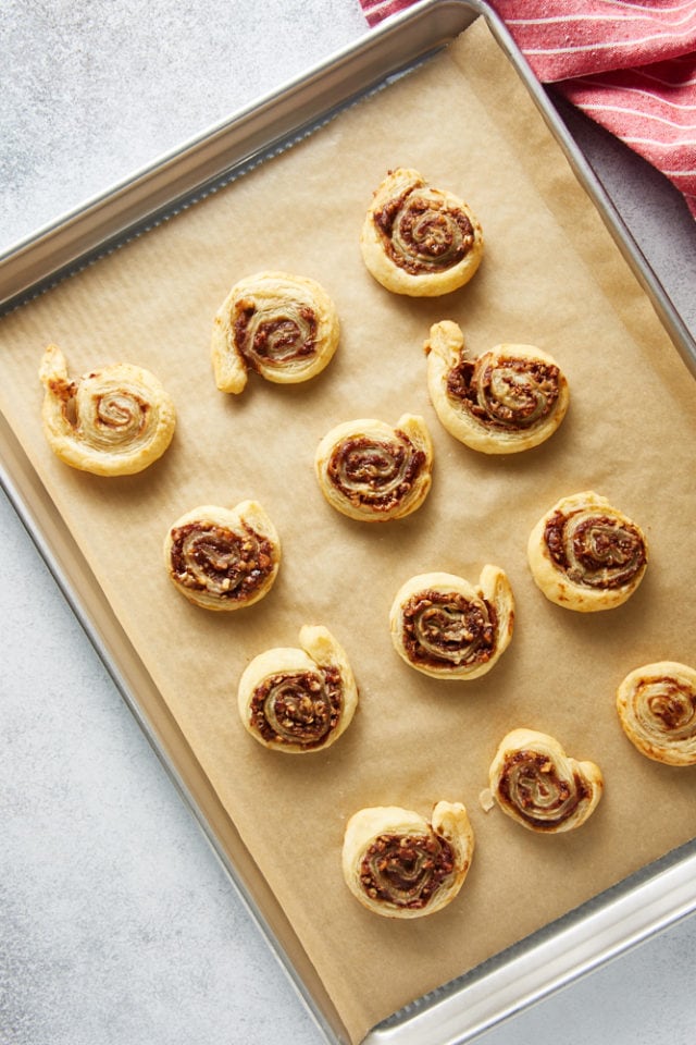overhead view of freshly baked Apple Butter Pinwheels on a parchment-lined baking sheet