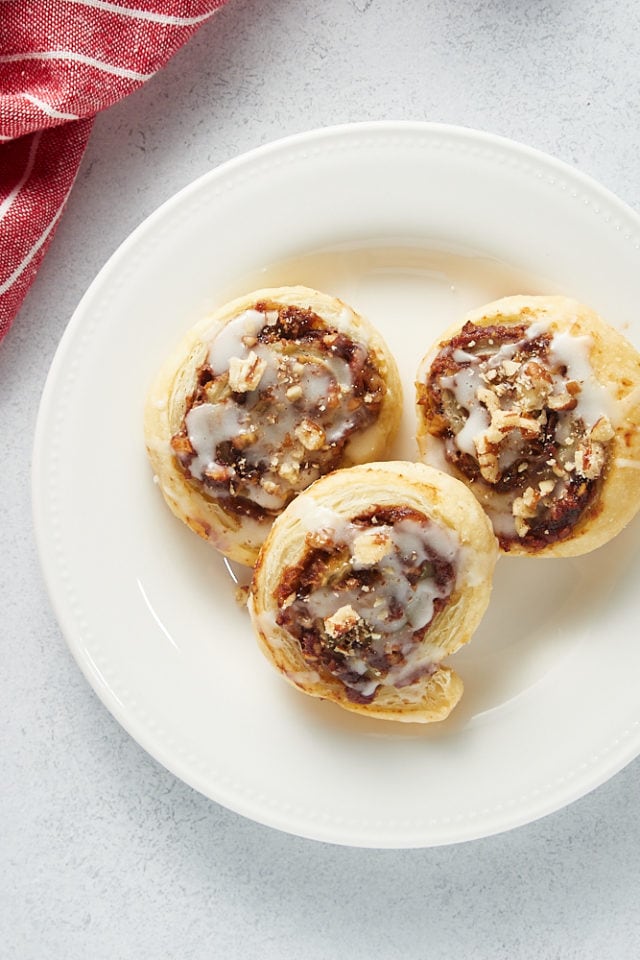 overhead view of three Apple Butter Pinwheels on a white plate